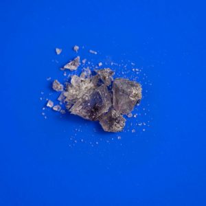 MDMA purple crystals on blue background