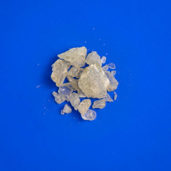 Clear MDMA crystals on blue background