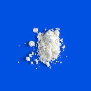 small pile of mescaline powder on blue background